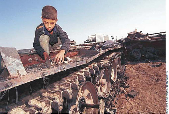 Ayad, 11, strips aluminium and other sellable metals from a tank potentially contaminated by DU